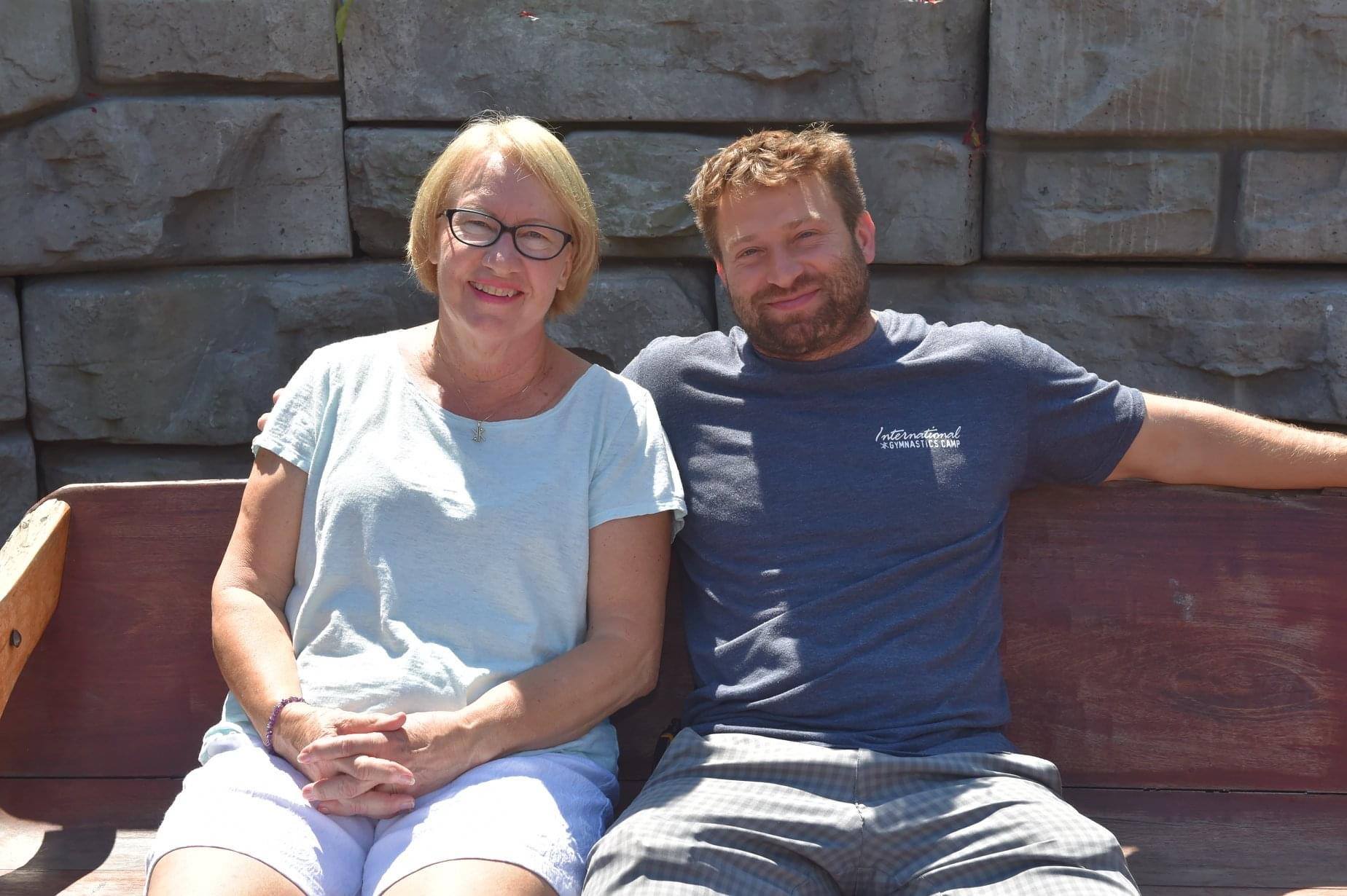 Cheryl & Brent Klaus sitting on a bench smiling
