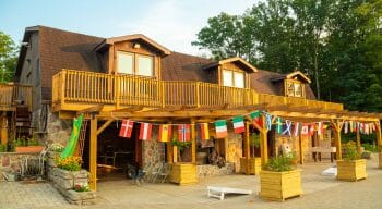 large cabin with balcony and string of flags hanging outside
