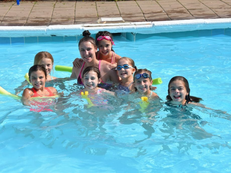 girls in the pool with one of their instructors