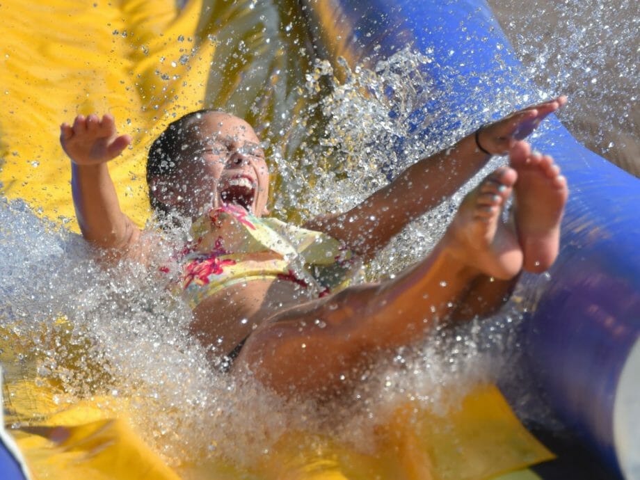 younger girl sliding down the waterslide