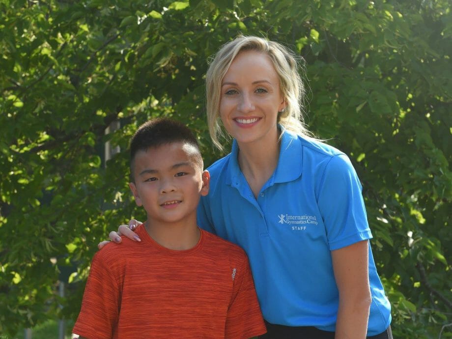 boy posing for a photo with Nastia Liukin