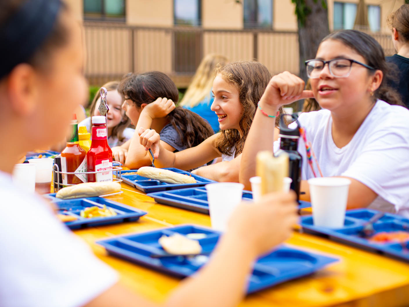 campers eating at the outside picnic tables