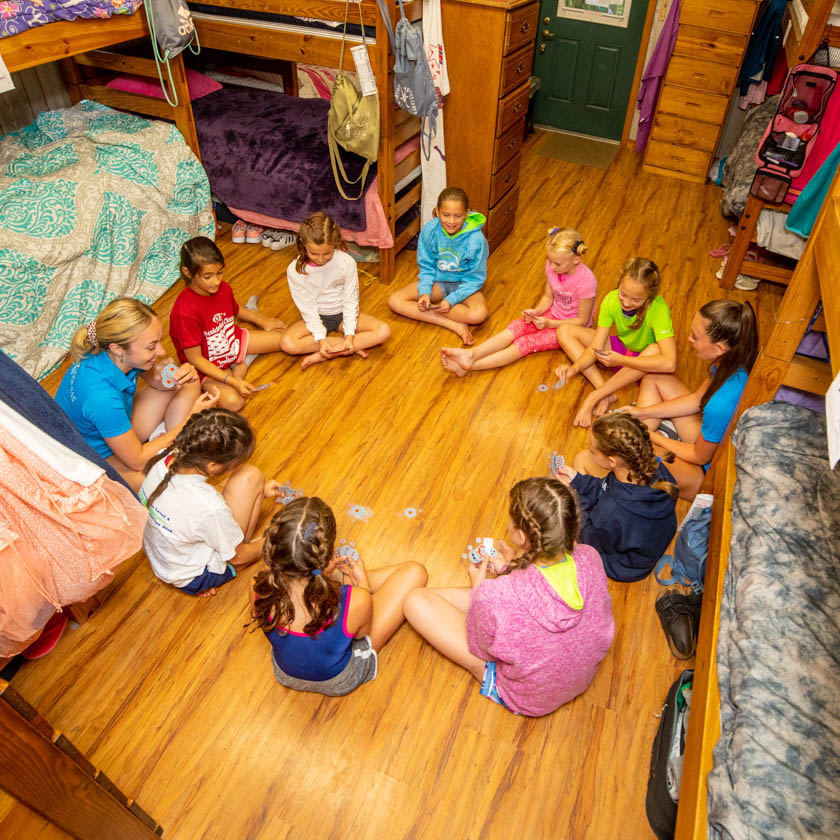 campers sitting in a circle in their cabin