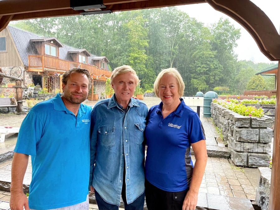 Brent and two others smiling for photo outside