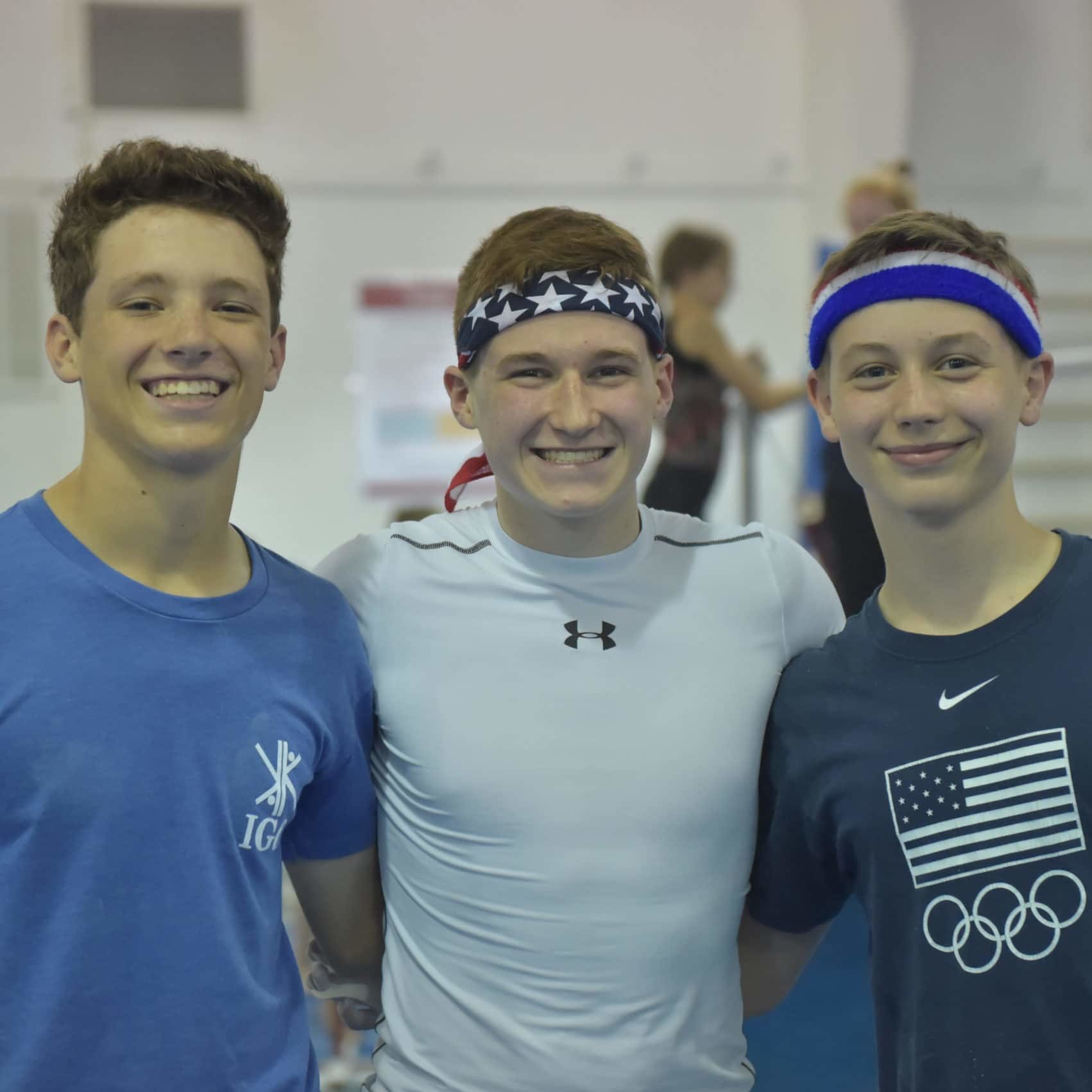 Three campers pose for a photo. Two campers are wearing headbands.