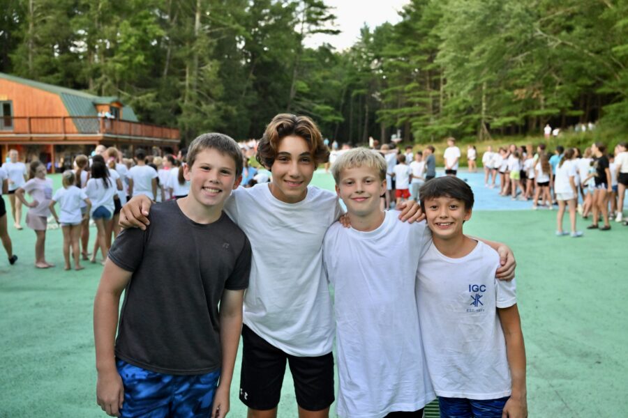 four campers take a break from a group activity for a photo.