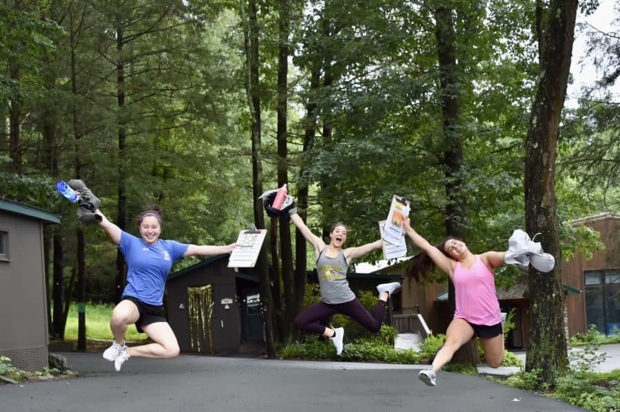 IGC staff members jumping in the air for a photo