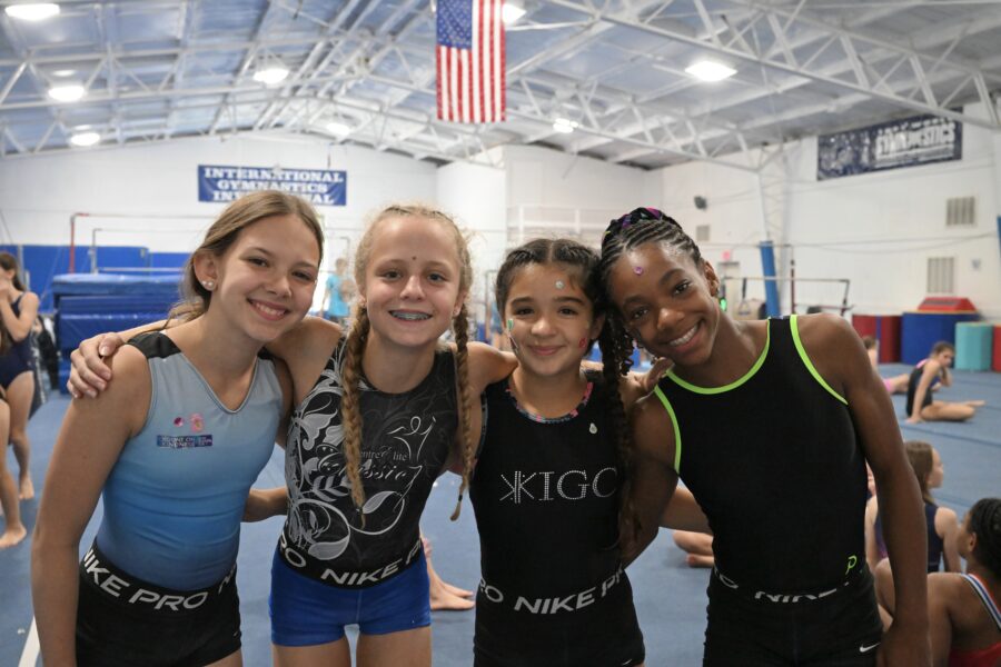 Girls taking a break from an activity at gymnastics camp.