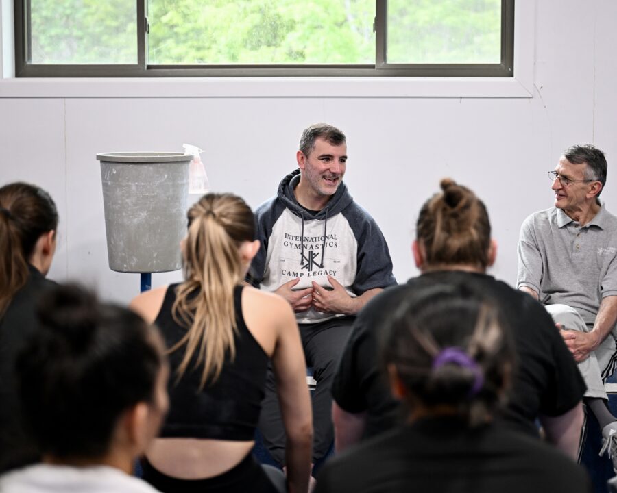 Brad Eclair addresses a group of people while wearing an IGC legacy sweatshirt.