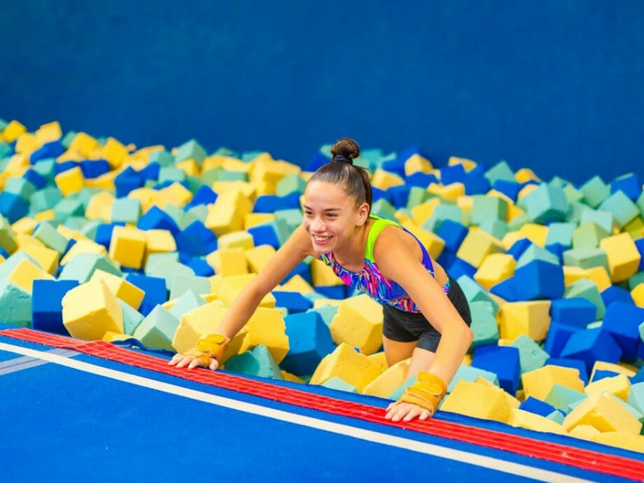 girl getting out of one of the foam pits